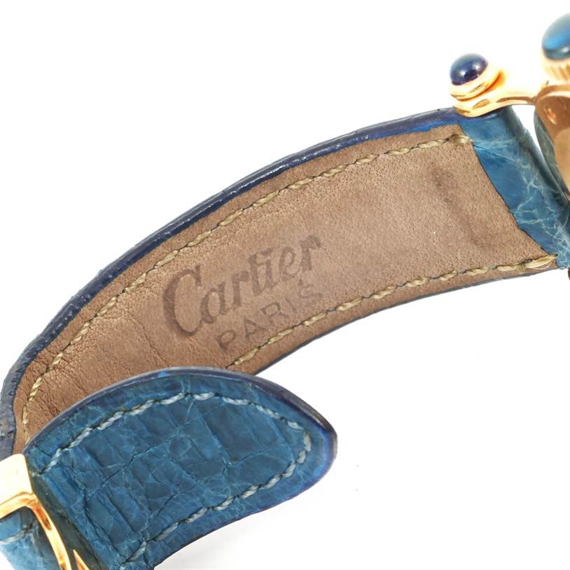 This image shows the inside of the strap of a Cartier Diabolo 1400 Women
s Yellow Gold Silver Dial 1400 Women
s Yellow Gold Silver Dial watch, highlighting the "Cartier Paris" imprint and blue leather band.