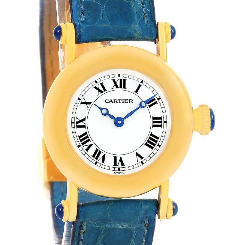 The image shows a front angle of the Cartier Diabolo 1400 Women
s Yellow Gold Silver Dial 1400 Women
s Yellow Gold Silver Dial watch, highlighting its yellow-gold case, blue strap, and Roman numeral dial.