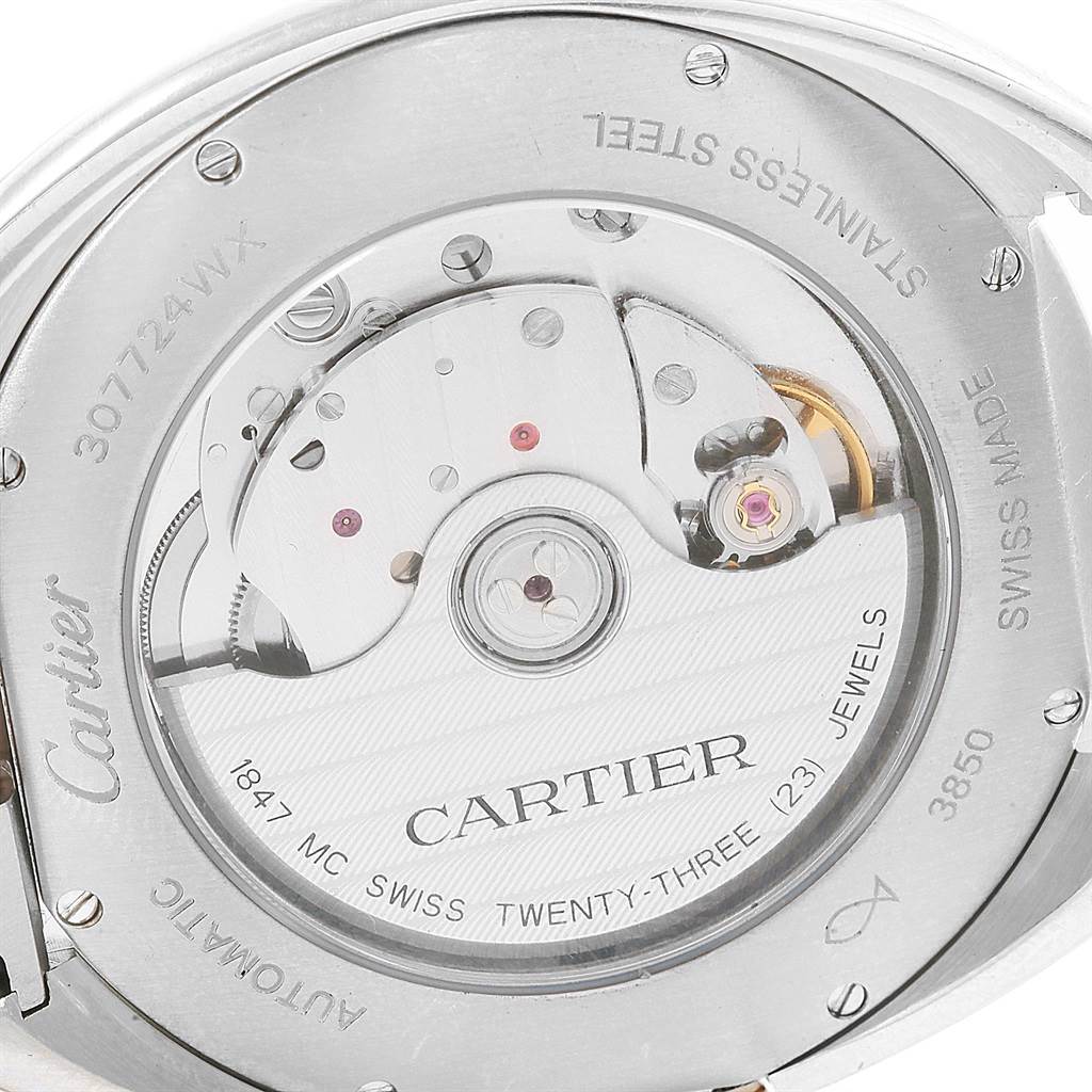 This is a close-up view of the movement and back of the Cartier Cle W2CL0002 Men's Steel and Gold (two tone) Silver Dial W2CL0002 Men's Steel and Gold (two tone) Silver Dial watch, showing its intricate internal mechanism and engravings.