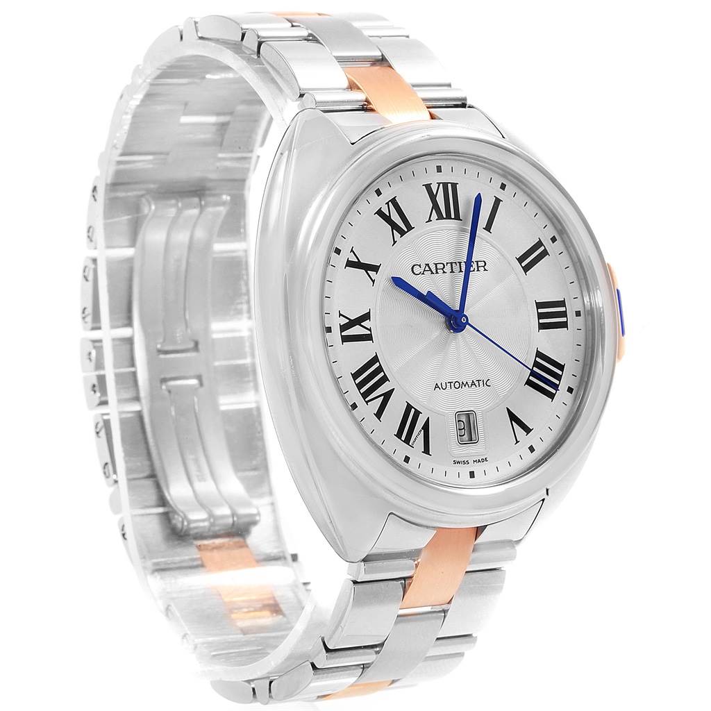 The image shows a Cartier Cle W2CL0002 Men's Steel and Gold (two tone) Silver Dial W2CL0002 Men's Steel and Gold (two tone) Silver Dial model watch from a front-side angle, highlighting its face, crown, and metal band.