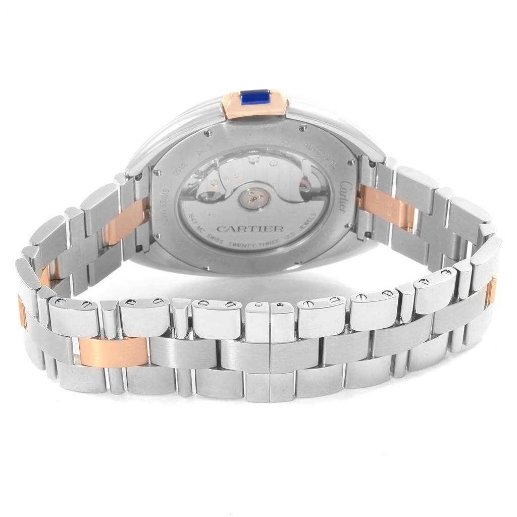 This image shows the back view of the Cle model watch by Cartier, highlighting the automatic movement and bi-metal bracelet.