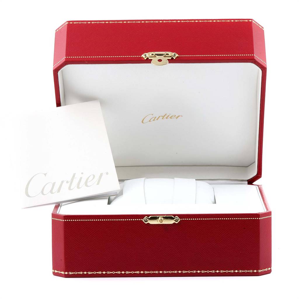 The image shows an open red Cartier box containing a Drive de Cartier watch cushion and booklet placed inside.