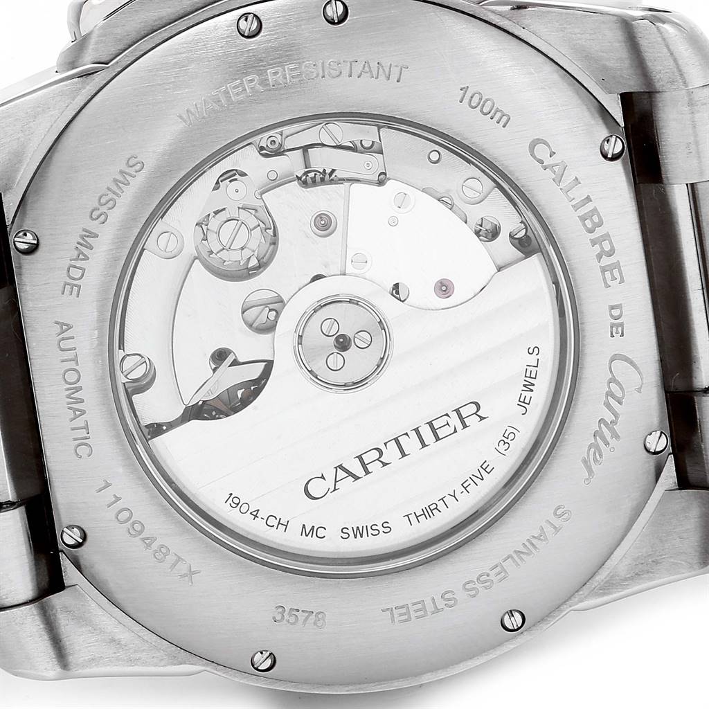 The image shows the back of a Calibre de Cartier watch by Cartier, highlighting its exposed automatic movement.
