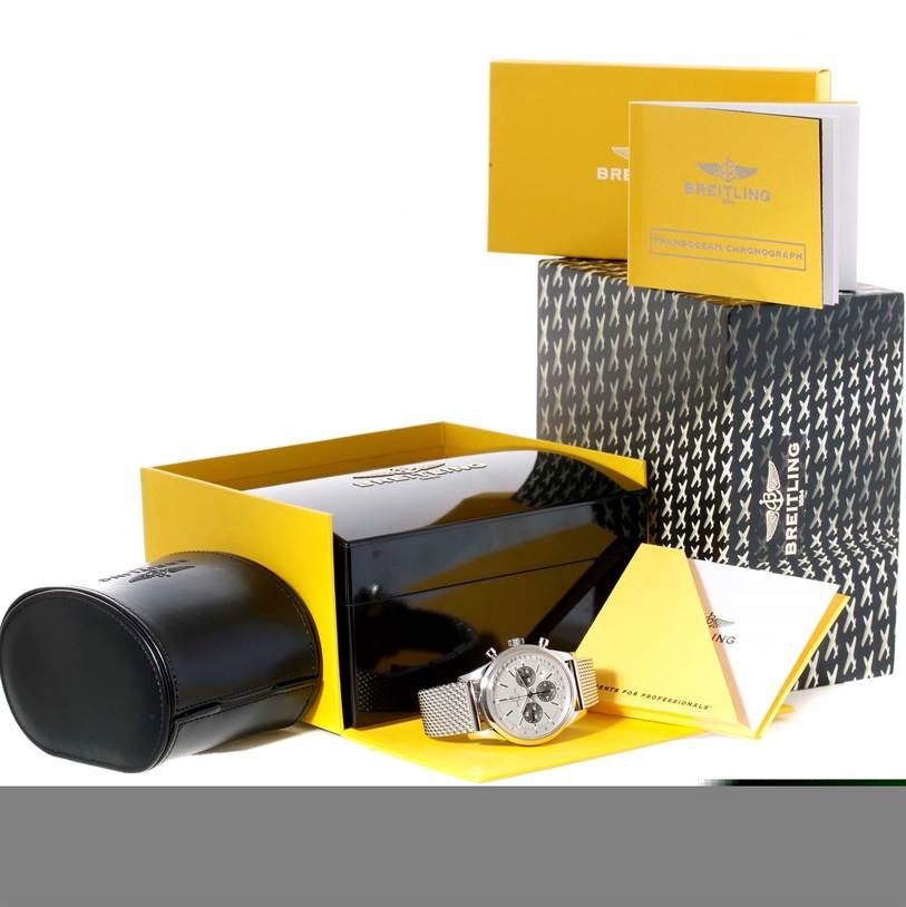 This image shows a Breitling Transocean AB015212/G724-154A Men
s Stainless Steel Silver Dial AB015212/G724-154A Men
s Stainless Steel Silver Dial watch and its accessories, including the case, box, and manuals, viewed from a slightly elevated angle.