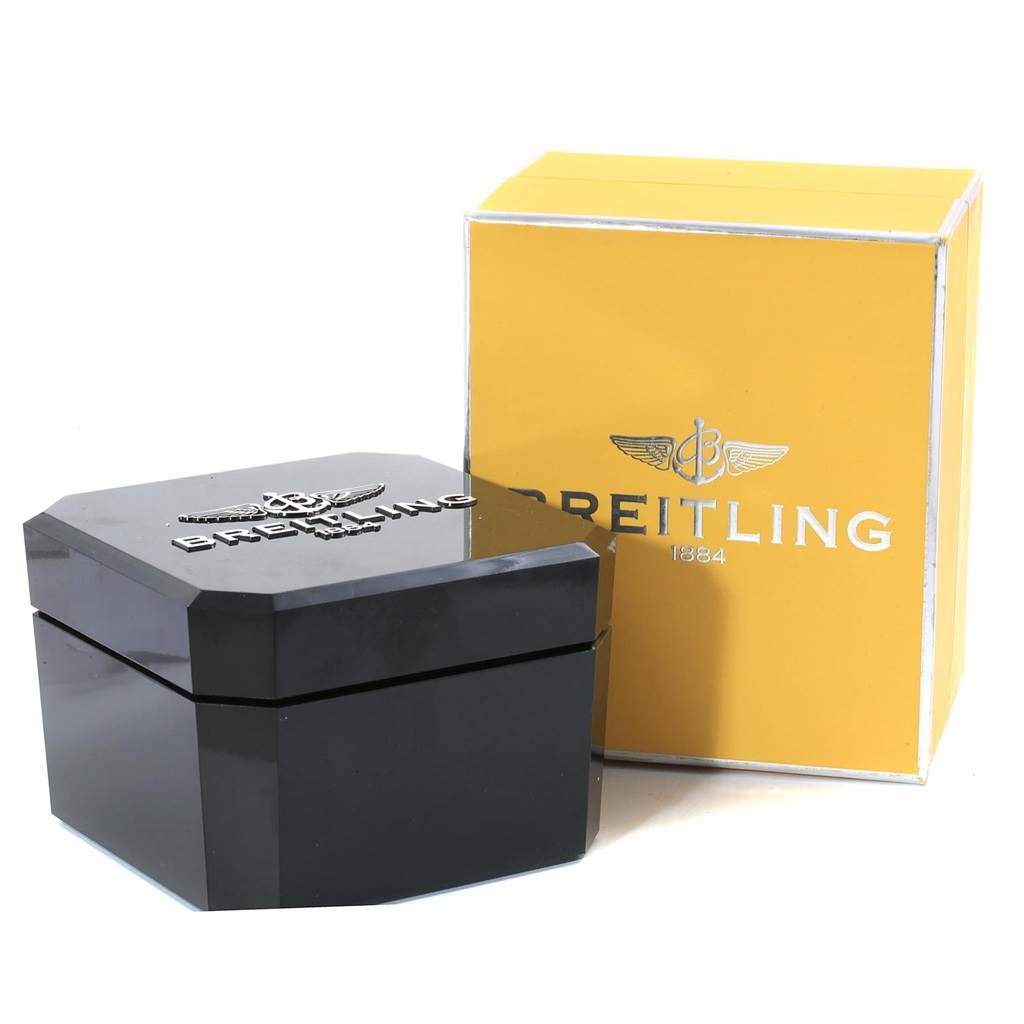 The image shows the packaging for the Breitling Transocean A19310 Men's Stainless Steel Silver Dial A19310 Men's Stainless Steel Silver Dial watch, including a black case and a yellow box.
