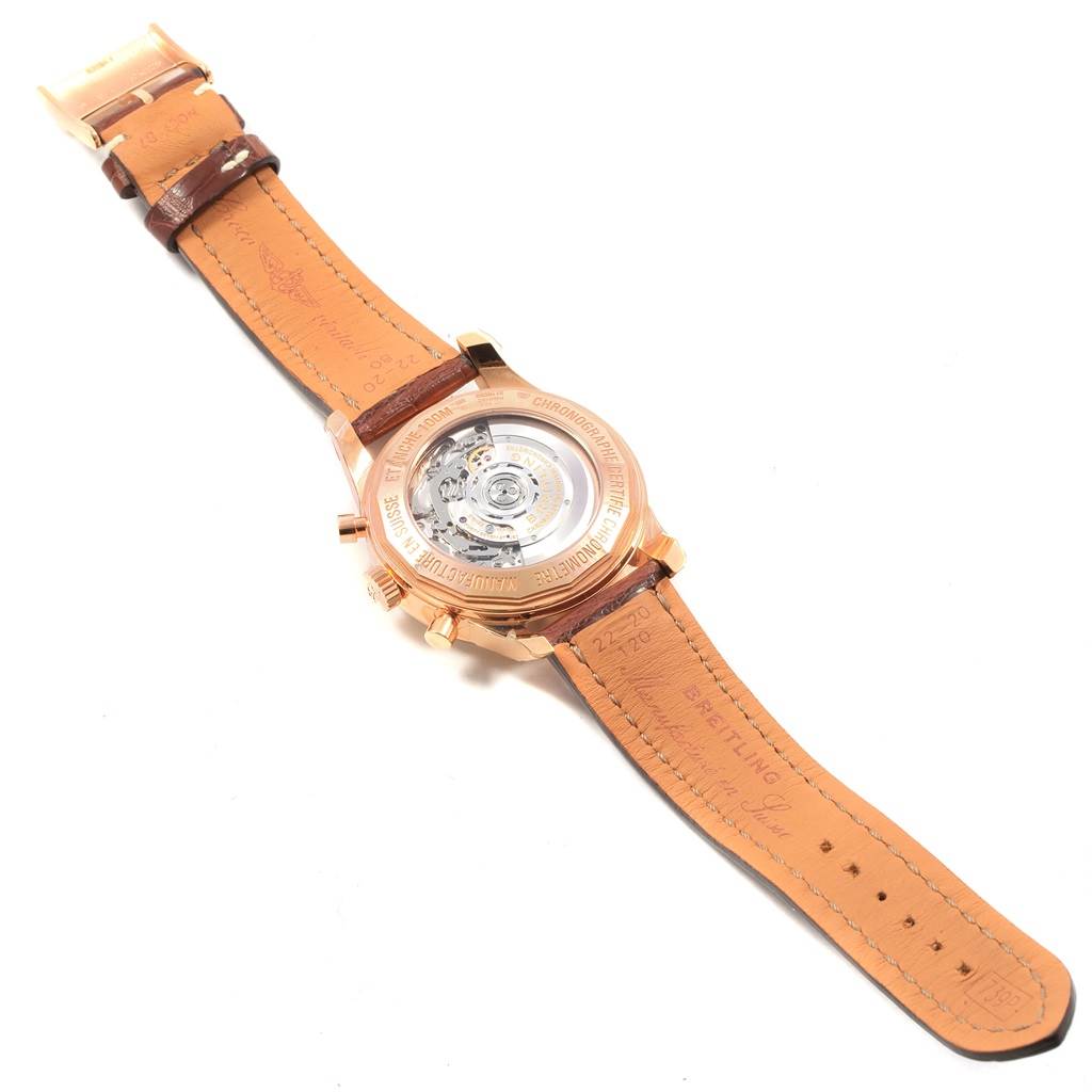 This image shows the back view of a Breitling Transocean RB0152 Men's Rose Gold Silver Dial RB0152 Men's Rose Gold Silver Dial watch, displaying its inner mechanism and leather strap.