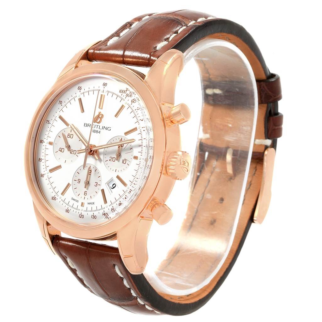 The Breitling Transocean RB0152 Men's Rose Gold Silver Dial RB0152 Men's Rose Gold Silver Dial watch is shown at an angle highlighting the dial, crown, pushers, and brown leather strap.