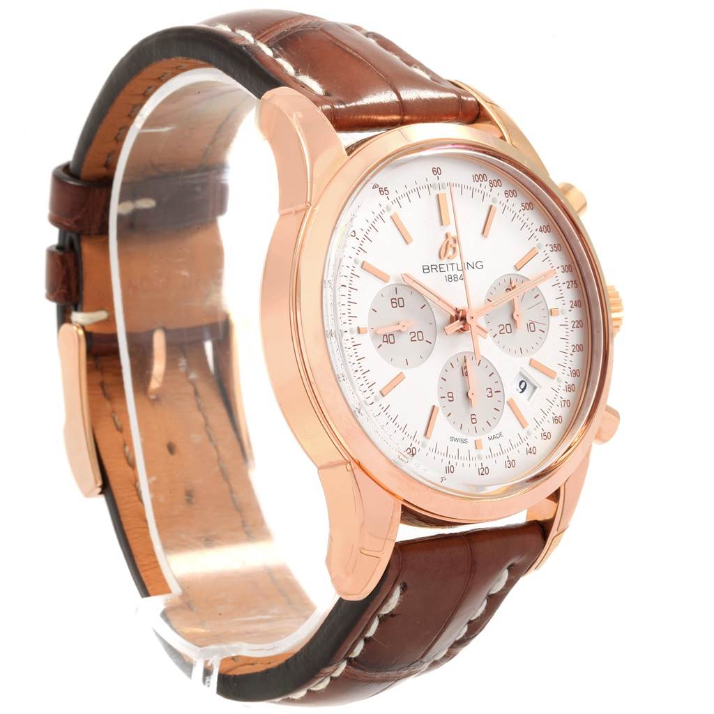 The image shows a Breitling Transocean RB0152 Men's Rose Gold Silver Dial RB0152 Men's Rose Gold Silver Dial watch at a front-left angle, highlighting its dial, chronograph subdials, and leather strap.