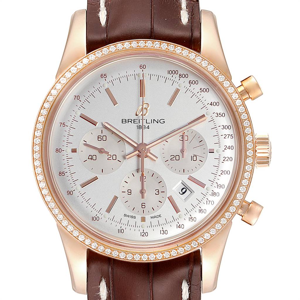 This image shows a front view of a Breitling Transocean RB0152 Men's Rose Gold Silver Dial RB0152 Men's Rose Gold Silver Dial watch with a diamond bezel and brown leather strap.