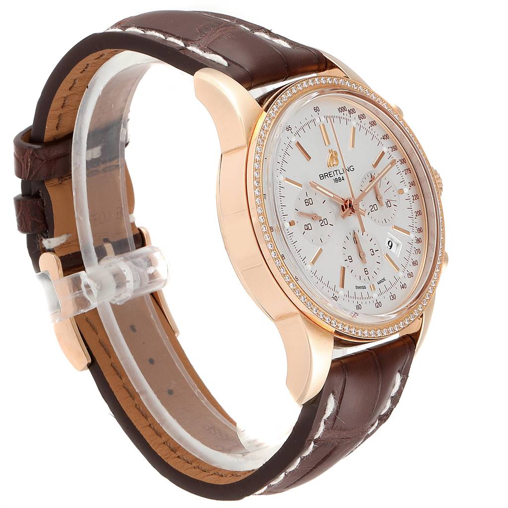 This image shows a side and partial front view of the Breitling Transocean RB0152 Men's Rose Gold Silver Dial RB0152 Men's Rose Gold Silver Dial watch with a brown leather strap and rose gold case.
