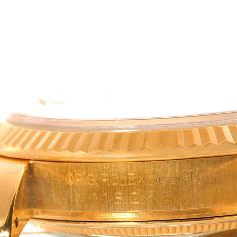 The image shows a close-up side view of the bezel and the engraved case of a Rolex President 118238 Men's Yellow Gold Silver Dial 118238 Men's Yellow Gold Silver Dial model watch.