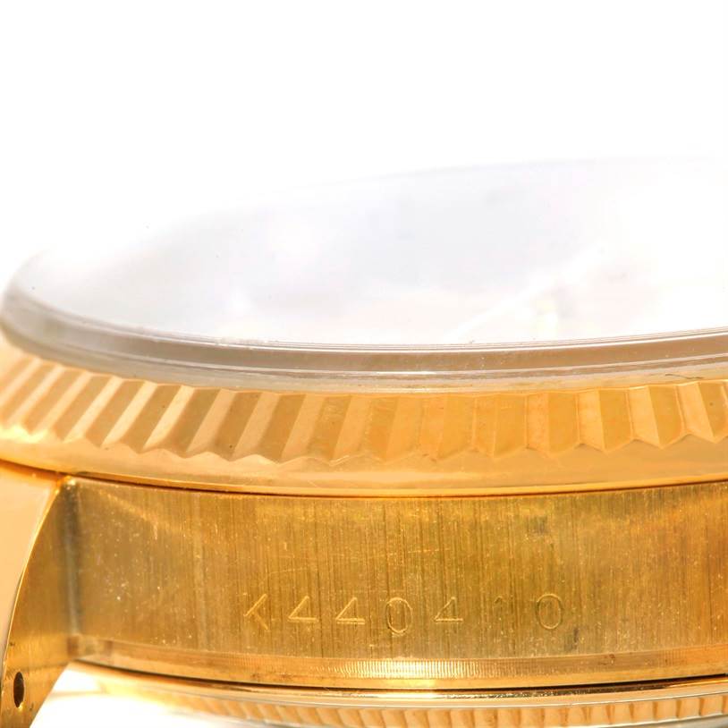 This close-up image shows the side case and bezel of a Rolex President 118238 Men's Yellow Gold Silver Dial 118238 Men's Yellow Gold Silver Dial watch.