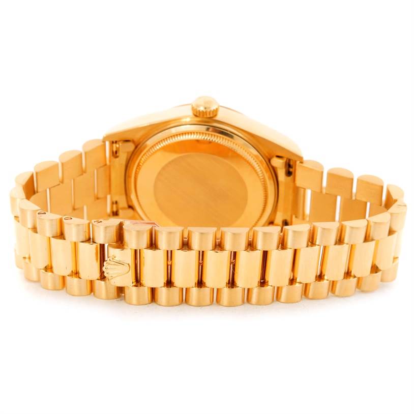 This image shows the back of the Rolex President 18038 Men
s Yellow Gold Silver Dial 18038 Men
s Yellow Gold Silver Dial model watch and its golden bracelet.