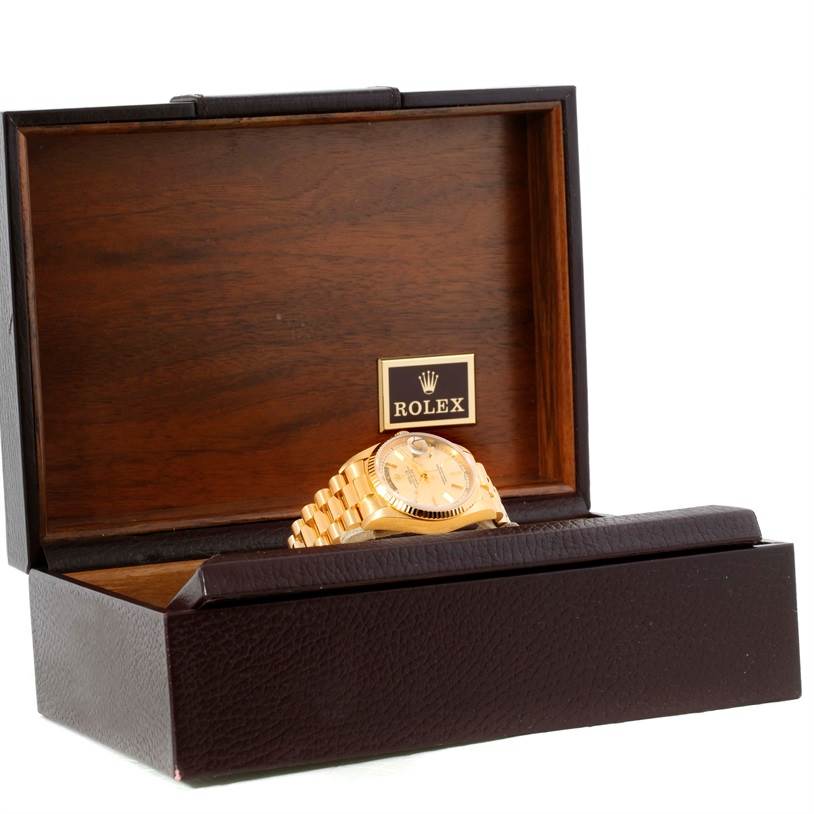 The image shows a Rolex President 18038 Men
s Yellow Gold Silver Dial 18038 Men
s Yellow Gold Silver Dial model watch angled inside an open wooden box with the bracelet and dial visible.