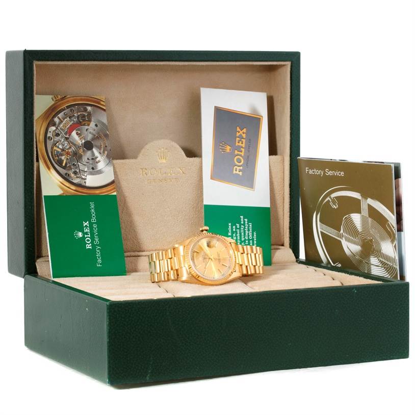 The image shows a Rolex President 18238 Men
s Yellow Gold Champagne Dial 18238 Men
s Yellow Gold Champagne Dial model watch in its case, along with service booklets and a warranty card.