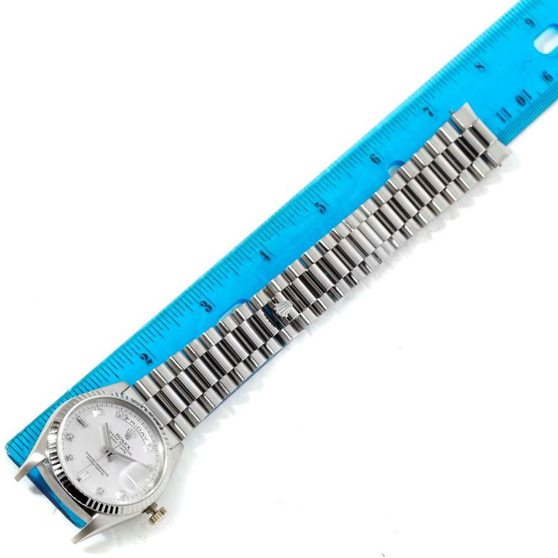 The image shows a Rolex President 18239 Men's White Gold Silver Dial 18239 Men's White Gold Silver Dial model watch laid flat next to a ruler, displaying its face and bracelet.