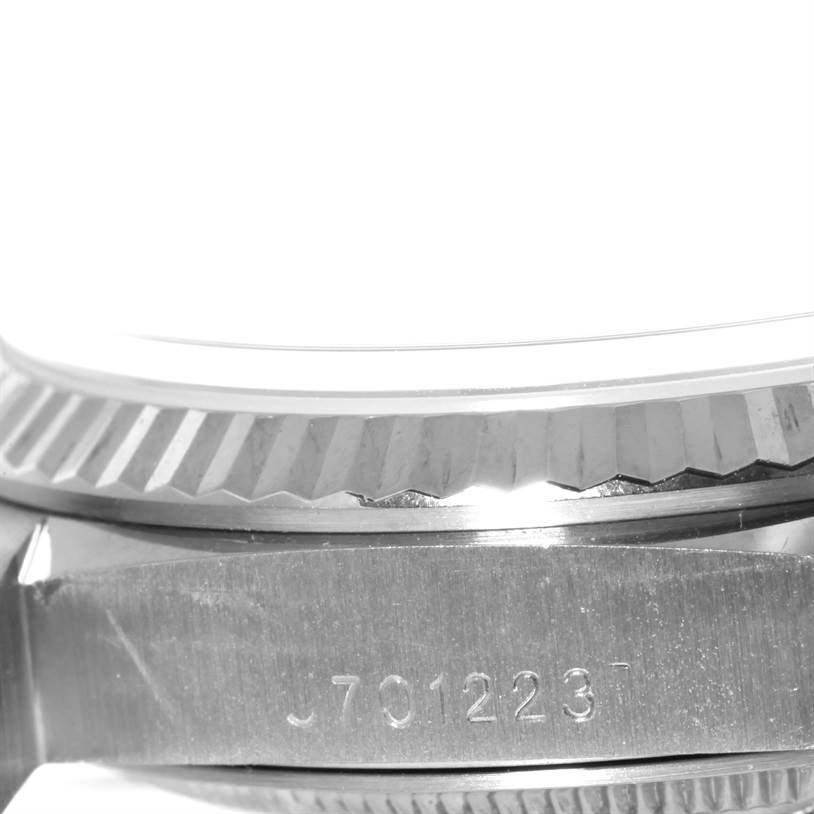 The image shows the side view of the case and bezel of a Rolex President 18239 Men's White Gold Silver Dial 18239 Men's White Gold Silver Dial model watch, showcasing part of the serial number.