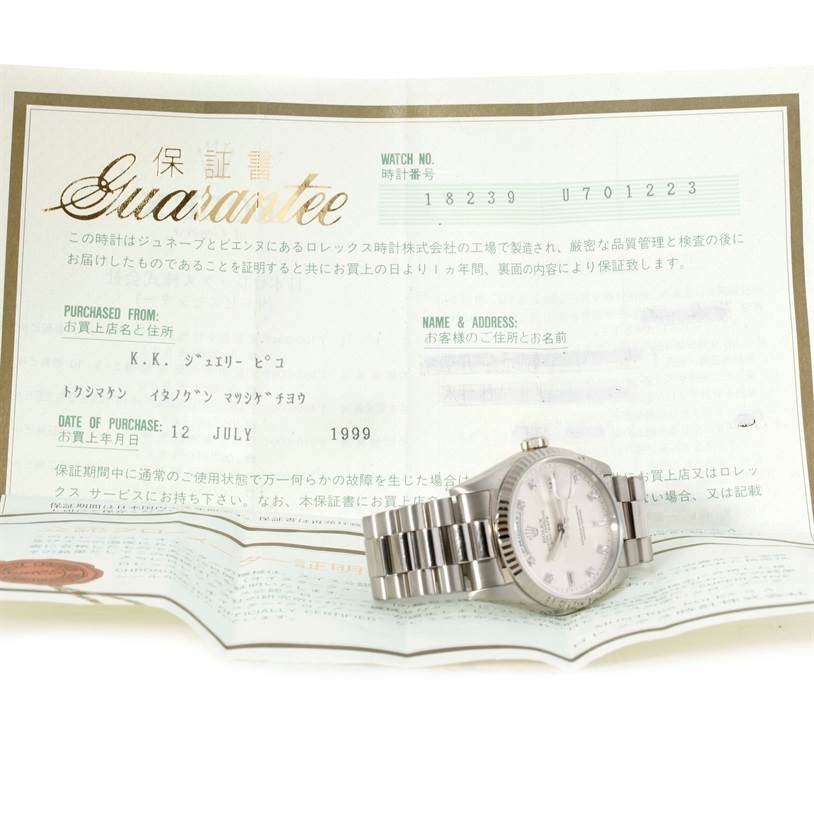The image shows a Rolex President 18239 Men's White Gold Silver Dial 18239 Men's White Gold Silver Dial model watch placed on top of a guarantee certificate, viewed from an angled top-down perspective.