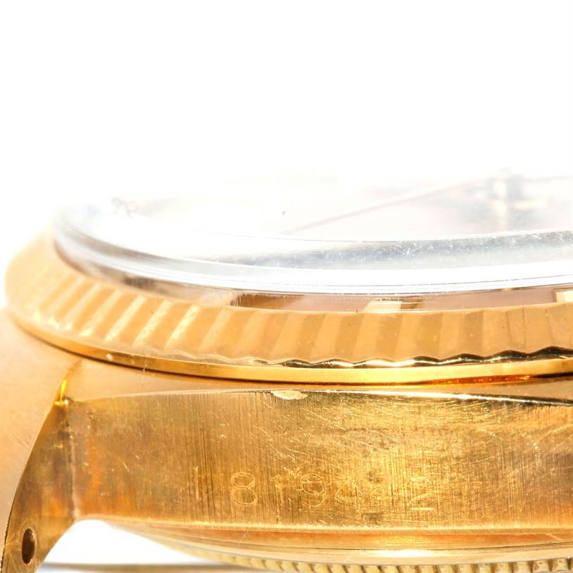 This image shows a side view of the Rolex President 1803 Men
s Yellow Gold Champagne Dial 1803 Men
s Yellow Gold Champagne Dial watch, highlighting the gold case, fluted bezel, and part of the crystal.