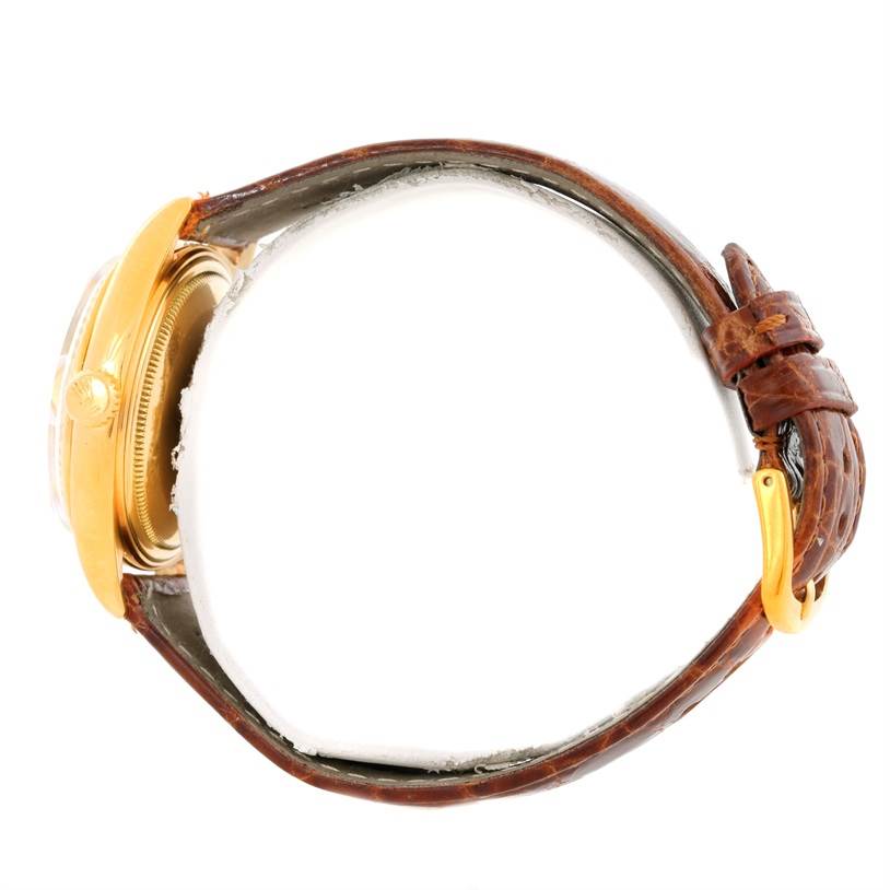 This image shows a side view of a Rolex President 1803 Men
s Yellow Gold Champagne Dial 1803 Men
s Yellow Gold Champagne Dial model watch, highlighting its brown leather strap and gold case.