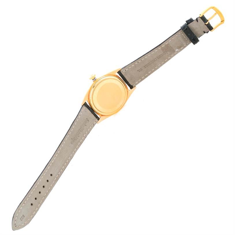 The image shows the back view of a Rolex President 1803 Men
s Yellow Gold White Dial 1803 Men
s Yellow Gold White Dial model watch, displaying the case, crown, and leather straps.