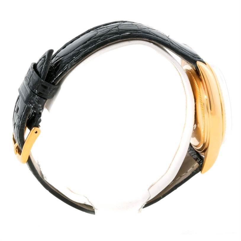 This image shows a side view of the Rolex President 1803 Men
s Yellow Gold White Dial 1803 Men
s Yellow Gold White Dial model watch, highlighting its black leather strap and gold case.