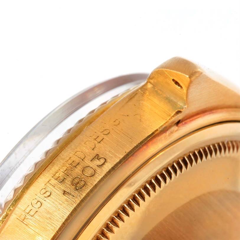 This close-up image of the Rolex President 1803 Men
s Yellow Gold White Dial 1803 Men
s Yellow Gold White Dial model watch shows the side view of the case with engraved details.