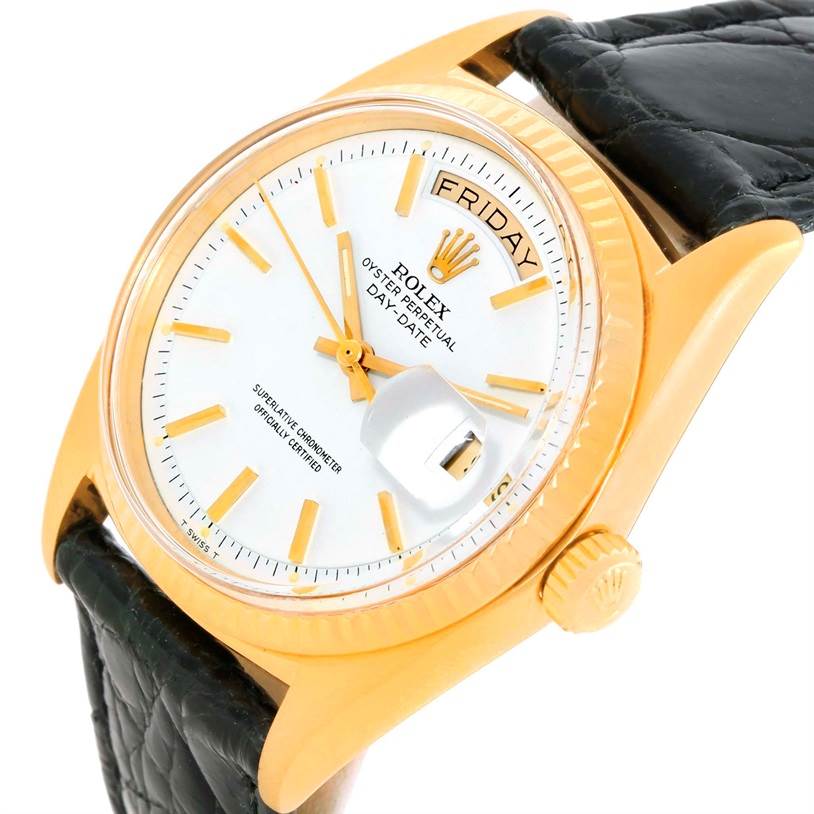 This is a close-up of a Rolex President 1803 Men
s Yellow Gold White Dial 1803 Men
s Yellow Gold White Dial model showing the face, crown, date, and part of the leather strap, angled slightly from above.