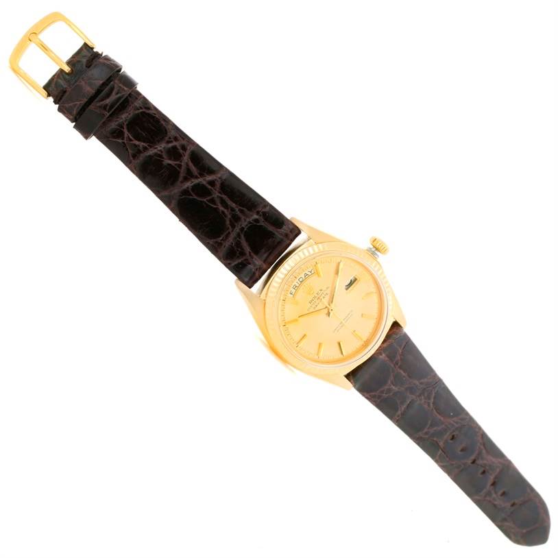 The Rolex President 1803 Men
s Yellow Gold Champagne Dial 1803 Men
s Yellow Gold Champagne Dial model watch is shown from a top-down angle, highlighting the face, crown, and leather strap.