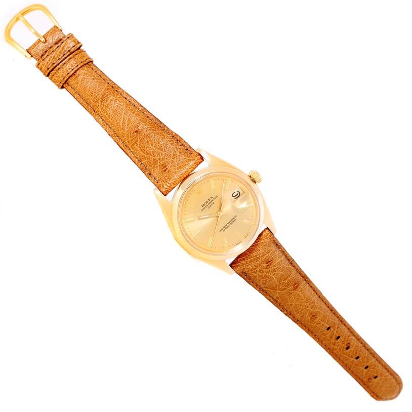 This image shows a Rolex President 1500 Men
s Yellow Gold Champagne Dial 1500 Men
s Yellow Gold Champagne Dial model watch from a top-down angle, highlighting its gold case, dial, and brown leather strap.