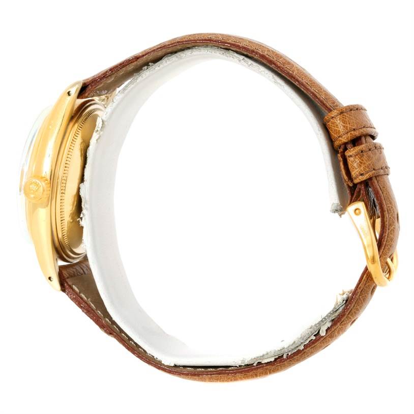 The image shows a side view of the Rolex President 1500 Men
s Yellow Gold Champagne Dial 1500 Men
s Yellow Gold Champagne Dial watch, highlighting its gold case, crown, and brown leather strap.