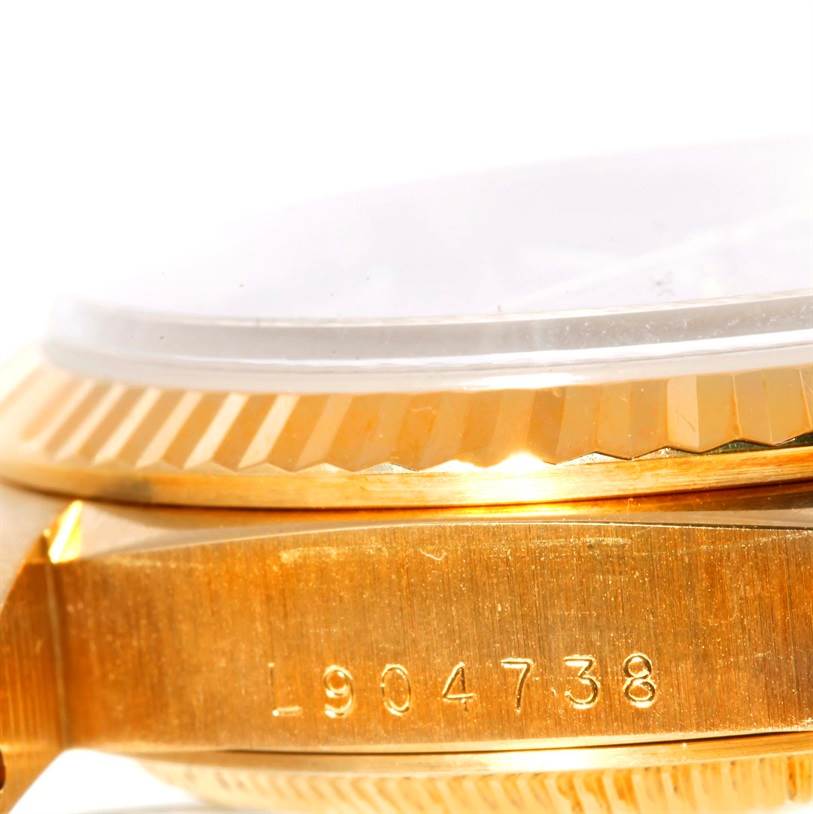 This image shows a close-up side view of the case and serial number of a Rolex President 18238 Men
s Yellow Gold Champagne Dial 18238 Men
s Yellow Gold Champagne Dial model watch.