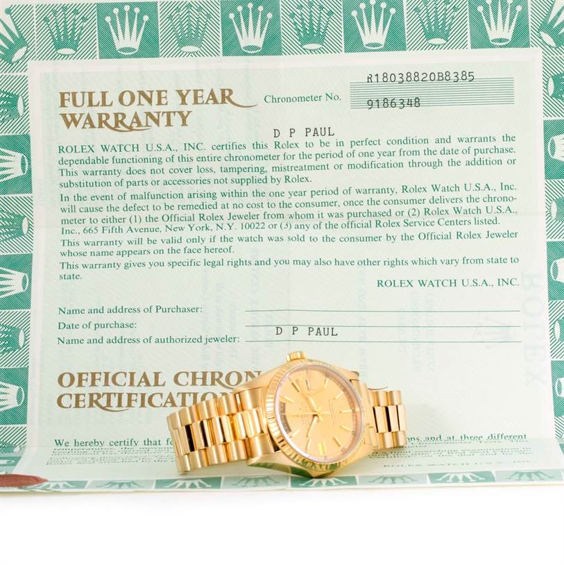 A Rolex President 18038 Men
s Yellow Gold Champagne Dial 18038 Men
s Yellow Gold Champagne Dial model watch is shown lying flat on an official one-year warranty document.