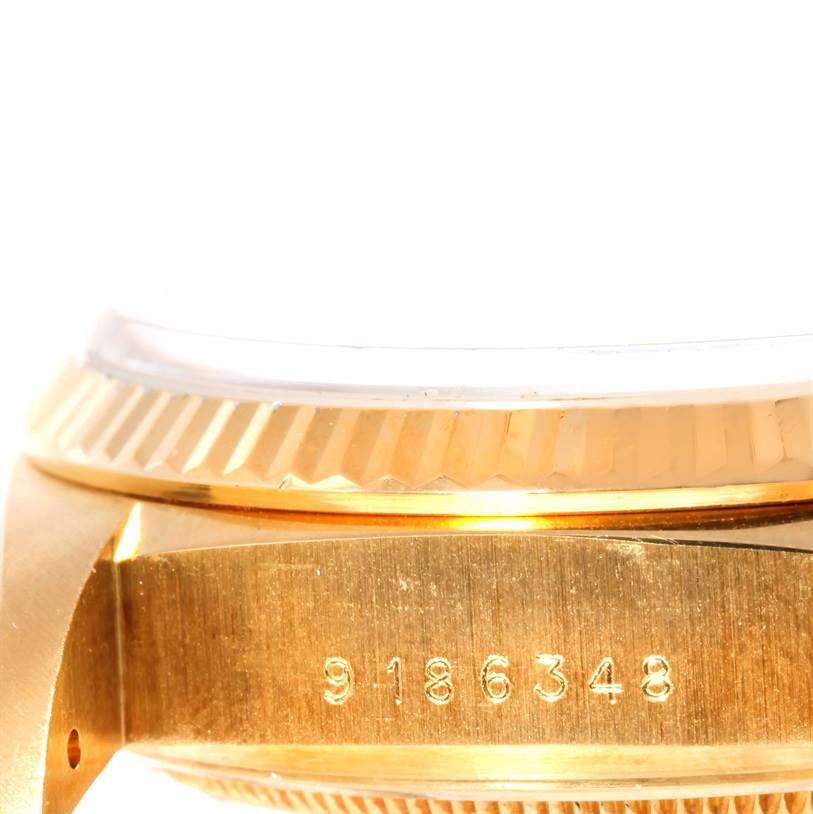 This close-up image of a Rolex President 18038 Men
s Yellow Gold Champagne Dial 18038 Men
s Yellow Gold Champagne Dial model watch shows the serial number on the side of the case and part of the bezel.