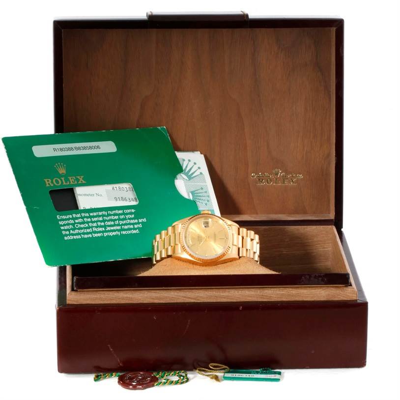 The image shows a Rolex President 18038 Men
s Yellow Gold Champagne Dial 18038 Men
s Yellow Gold Champagne Dial model watch inside an open box, with warranty papers and tags displayed.