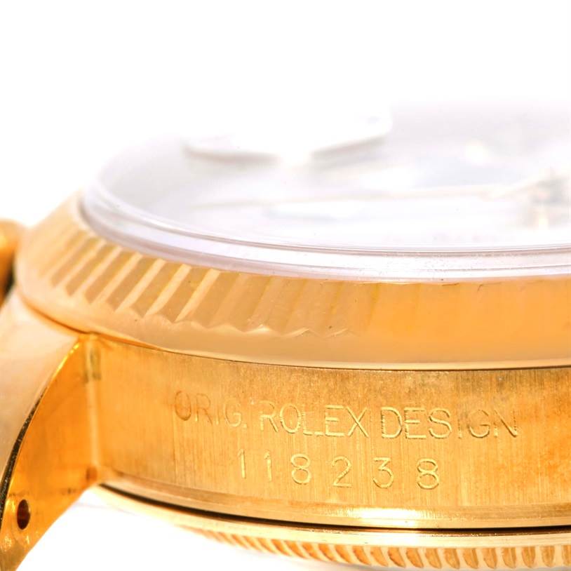 This is a close-up angle of the side of the Rolex President 118238 Men
s Yellow Gold White Dial 118238 Men
s Yellow Gold White Dial model watch, showing the serial number and part of the bezel.