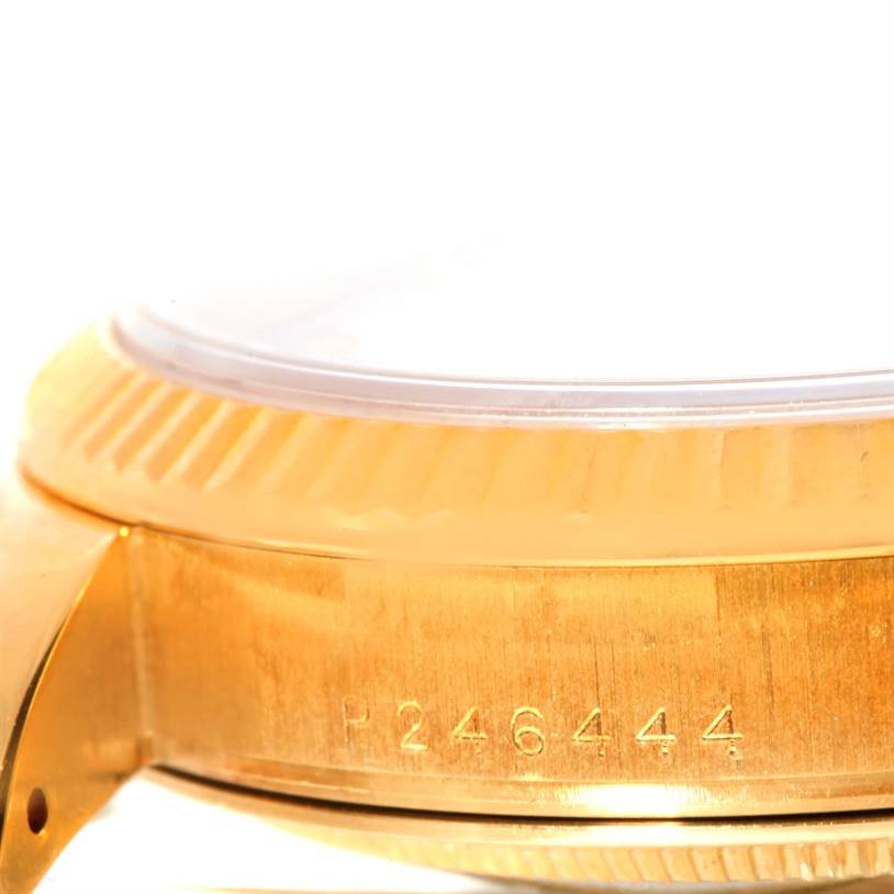 This image shows a close-up side view of the Rolex President 118238 Men
s Yellow Gold White Dial 118238 Men
s Yellow Gold White Dial model, highlighting the fluted bezel and partial serial number.