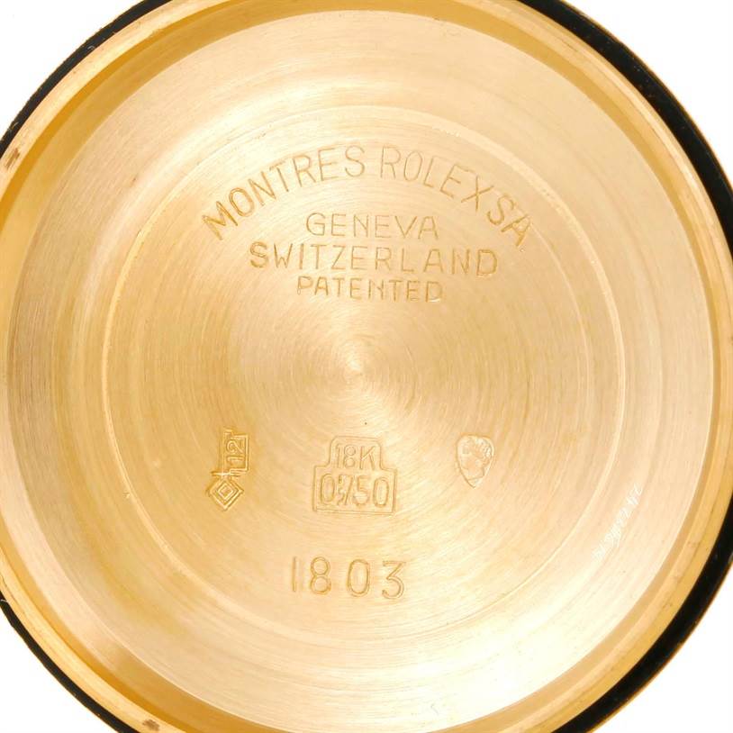 This is an inside view of the case back of a Rolex President 1803 Men
s Yellow Gold Champagne Dial 1803 Men
s Yellow Gold Champagne Dial model watch, showing the brand
s inscriptions and gold purity stamps.