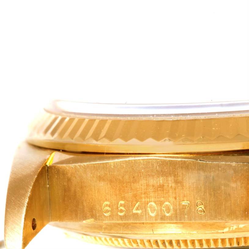 The image shows a close-up angle of the side and bezel of a Rolex President 18038 Men's Yellow Gold Blue Dial 18038 Men's Yellow Gold Blue Dial model watch, with part of the serial number visible.