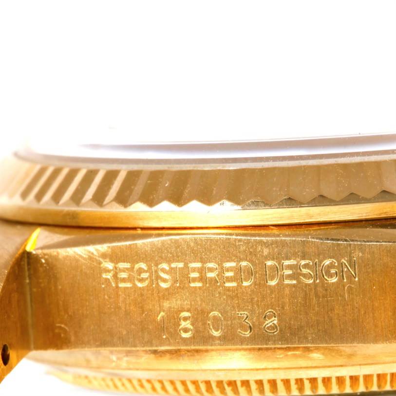 The image shows a close-up side view of the Rolex President 18038 Men's Yellow Gold Blue Dial 18038 Men's Yellow Gold Blue Dial watch model, focusing on the case and part of the bezel with "REGISTERED DESIGN 18038" engraved.