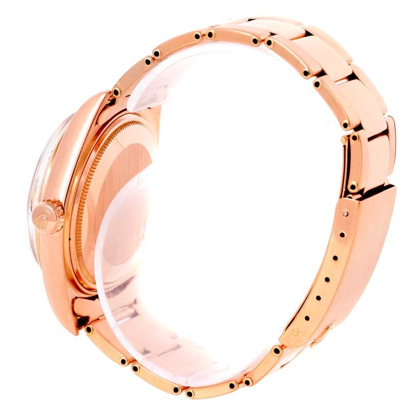 The Rolex President 1803 Men's Rose Gold Pink Dial 1803 Men's Rose Gold Pink Dial model watch is shown from a side angle, displaying the crown, case, and part of the bracelet.