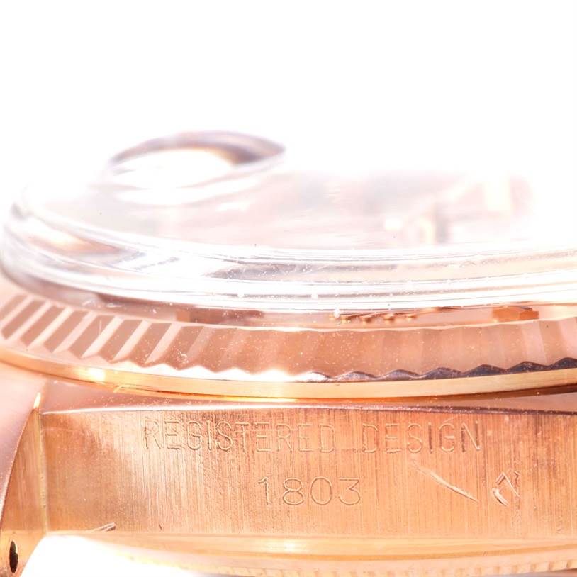This image shows a close-up side view of a Rolex President 1803 Men's Rose Gold Pink Dial 1803 Men's Rose Gold Pink Dial model watch, highlighting the bezel and case with the model number 1803 engraved.