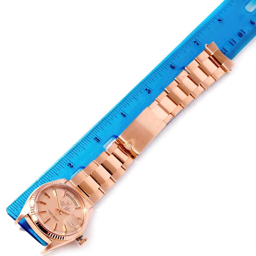 The image shows a Rolex President 1803 Men's Rose Gold Pink Dial 1803 Men's Rose Gold Pink Dial model watch laid flat, with a blue ruler measuring its length.