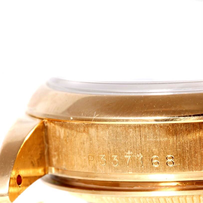 This image shows the side and part of the case and bezel of a Rolex President 118208 Men's Yellow Gold Black Dial 118208 Men's Yellow Gold Black Dial model watch, displaying its serial number.