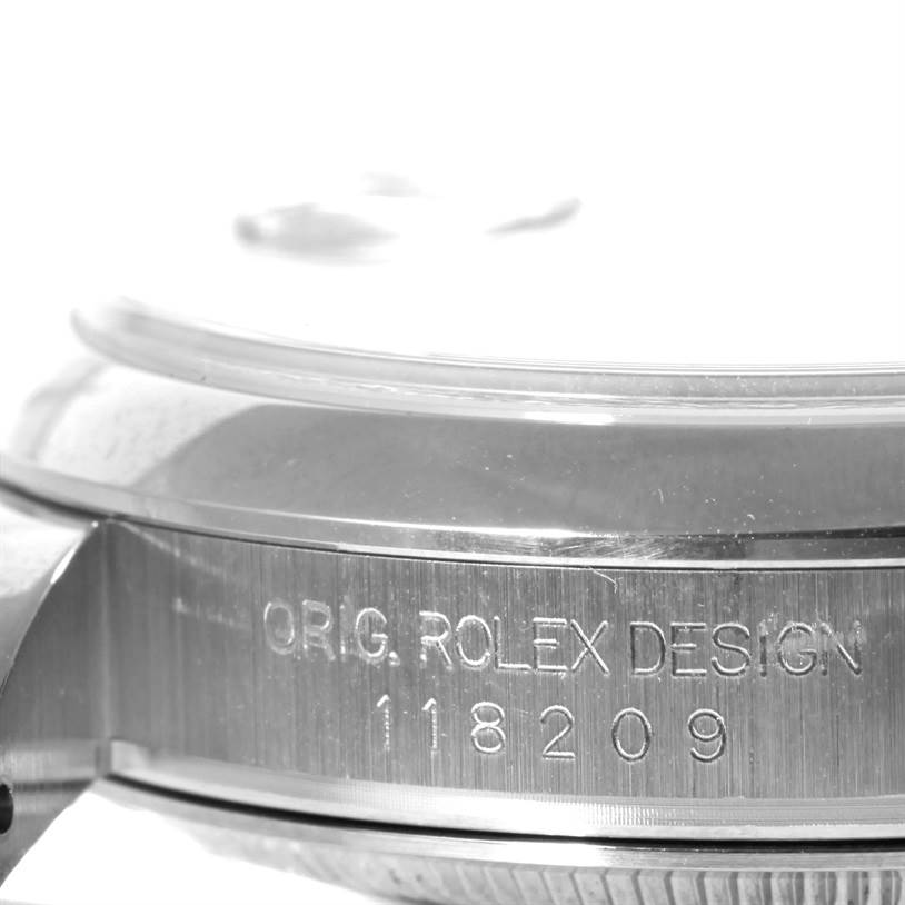 This image displays a close-up of the side of the case with engraving from a Rolex President 118209 Men's White Gold Silver Dial 118209 Men's White Gold Silver Dial model watch.