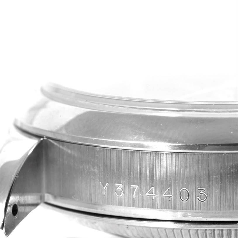 This close-up image of the Rolex President 118209 Men's White Gold Silver Dial 118209 Men's White Gold Silver Dial model shows the side of the watch case with its serial number engraved.