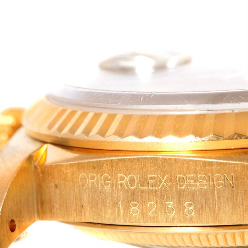 This close-up image shows the side view of a Rolex President 18238 Men
s Yellow Gold Champagne Dial 18238 Men
s Yellow Gold Champagne Dial model watch, highlighting the bezel and engraved model number.