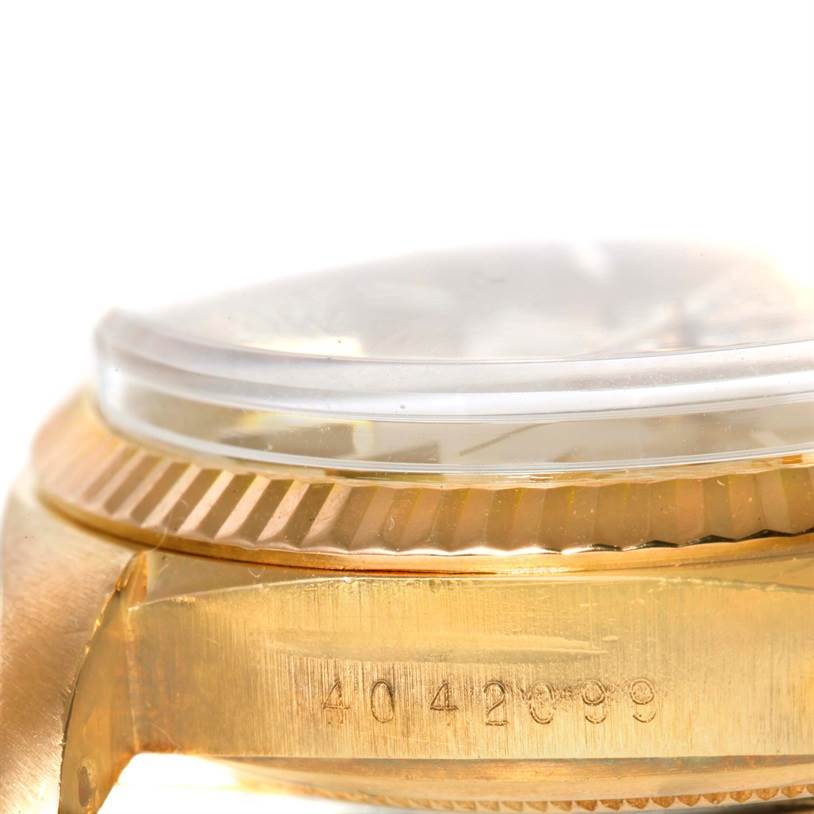 This close-up image shows the side view of a Rolex President 1803 Men
s Yellow Gold Champagne Dial 1803 Men
s Yellow Gold Champagne Dial model watch, showcasing the watch
s fluted bezel and serial number.