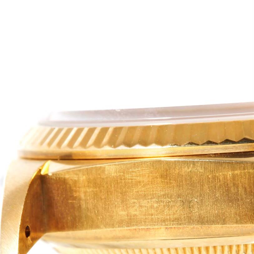 This close-up image shows the side of a gold Rolex President 18038 Men
s Yellow Gold Champagne Dial 18038 Men
s Yellow Gold Champagne Dial model, focusing on the case and bezel.