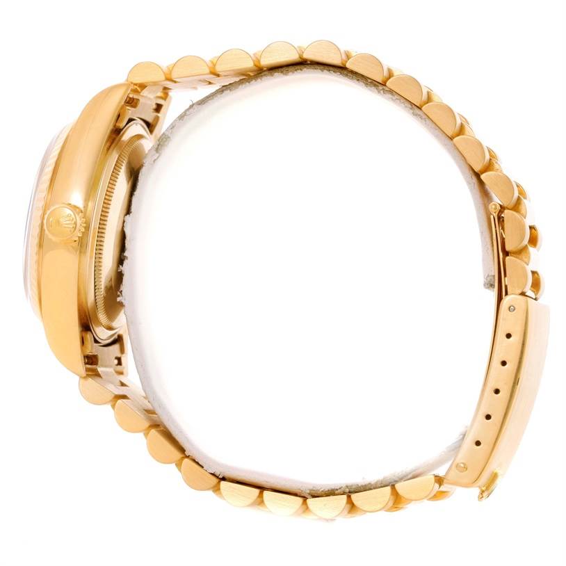 This image shows a side view of the Rolex President 18038 Men
s Yellow Gold Champagne Dial 18038 Men
s Yellow Gold Champagne Dial model watch, highlighting the watch case, crown, and part of the gold bracelet.